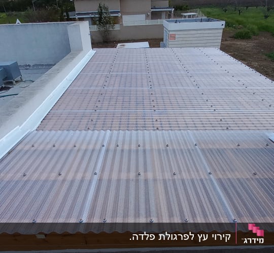 גג פלסטיק שקוף עם ברגים על מסגרת עץ